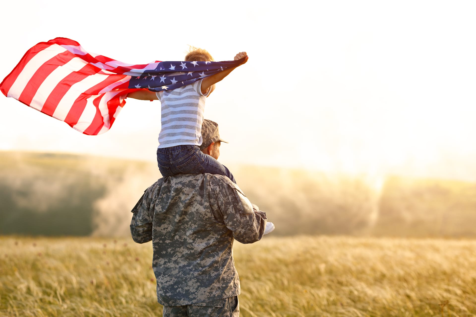 Soldier with child holding American flag